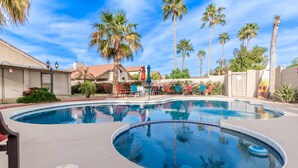 A swimming pool with lounge chairs and palm trees. - 4 Bedroom Incredible Backyard with Pool! (Glendale)