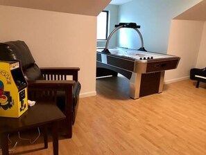 Relax in a cozy space with a foosball table and comfortable seating.