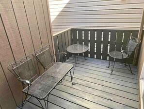 Enjoy dining or socializing on the patio with a wooden deck and comfortable seating.