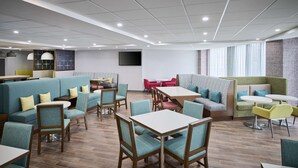 A modern dining area with booths, tables, and chairs.