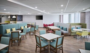 A modern dining area with booths, tables, and chairs.