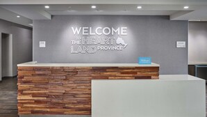A reception desk with a 'Welcome to Heartland Province' sign, a 'Manager On Duty' sign, and a 'Hilton Honors' sign. - Hampton Inn by Hilton Hamilton (Hamilton)