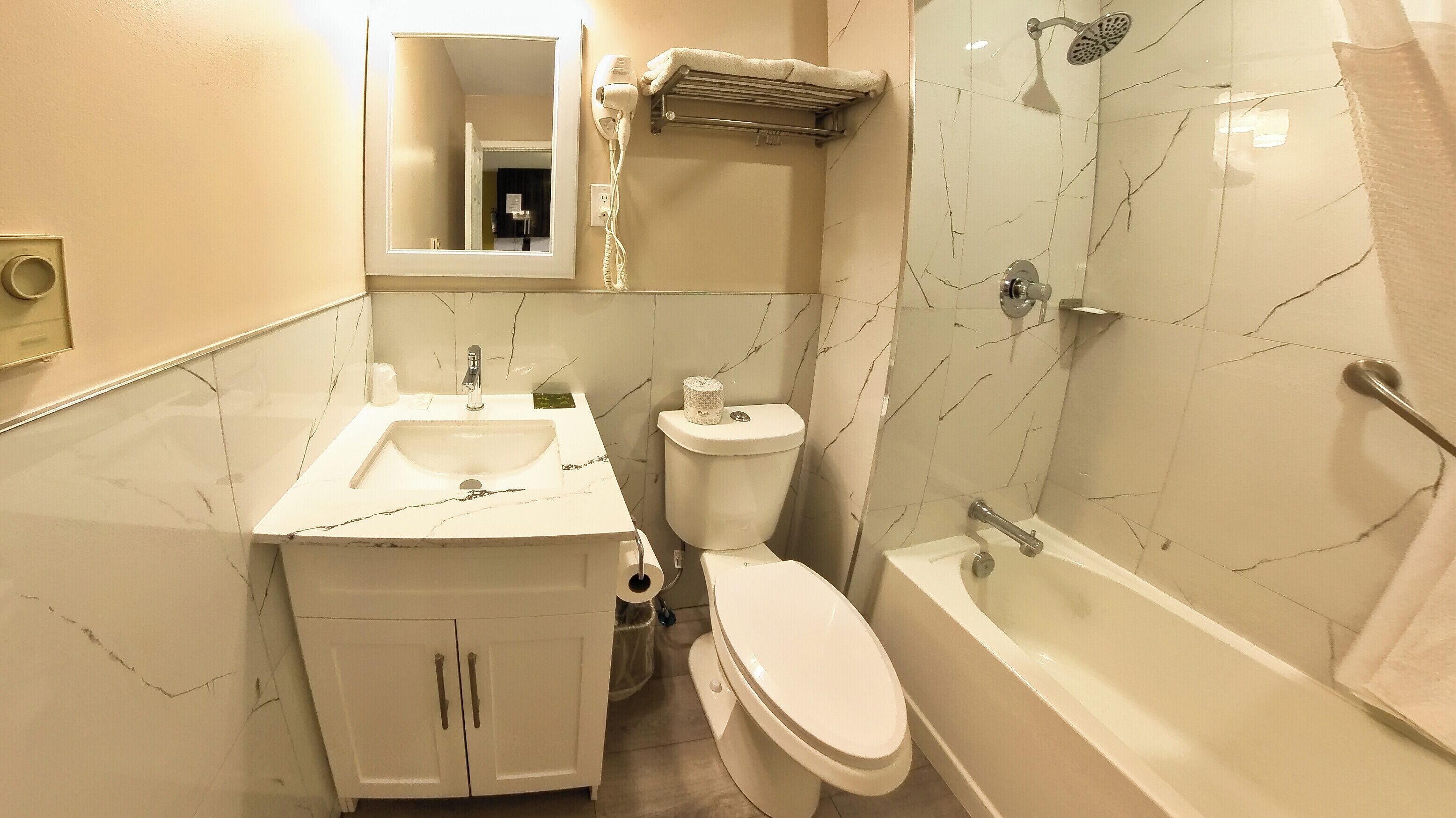 A bathroom with a sink, toilet, and bathtub.