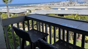 A balcony with a view of the beach and ocean. - Sunset Harbor and Ocean Views, Modern Coastal Design, Beachfront Resort (Oceanside)
