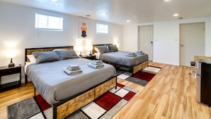 A modern bedroom with two beds, wooden headboards, and a built-in wardrobe. - 3 Mi to Downtown: Pittsburgh Home w/ Balcony! (Pittsburgh)