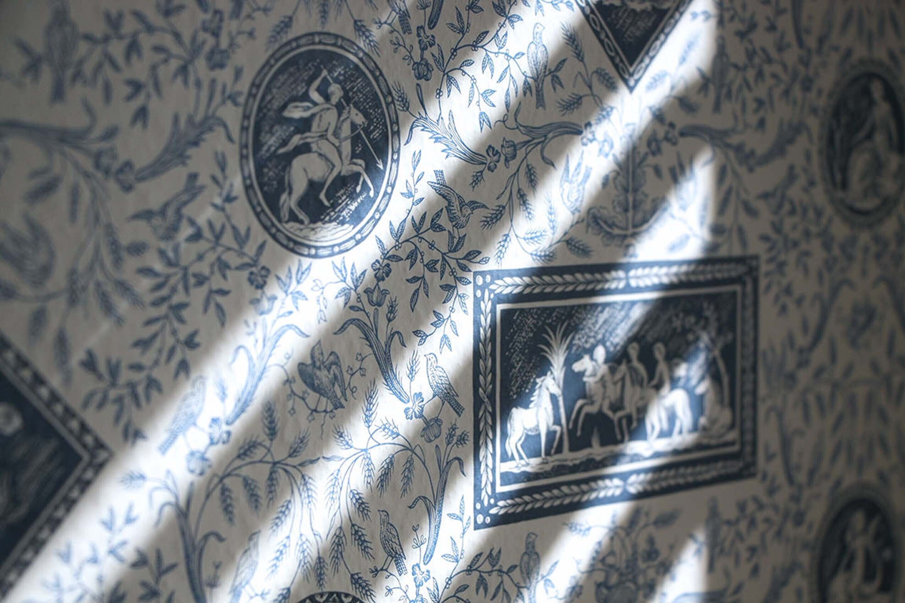 A fabric with intricate blue patterns, including circular and rectangular designs.