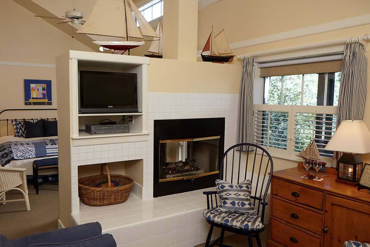 A cozy living room with a fireplace, television, and comfortable seating.
