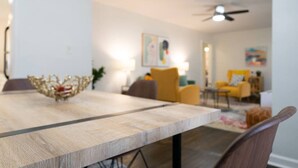 A dining area with a wooden table, chairs, and a decorative bowl.