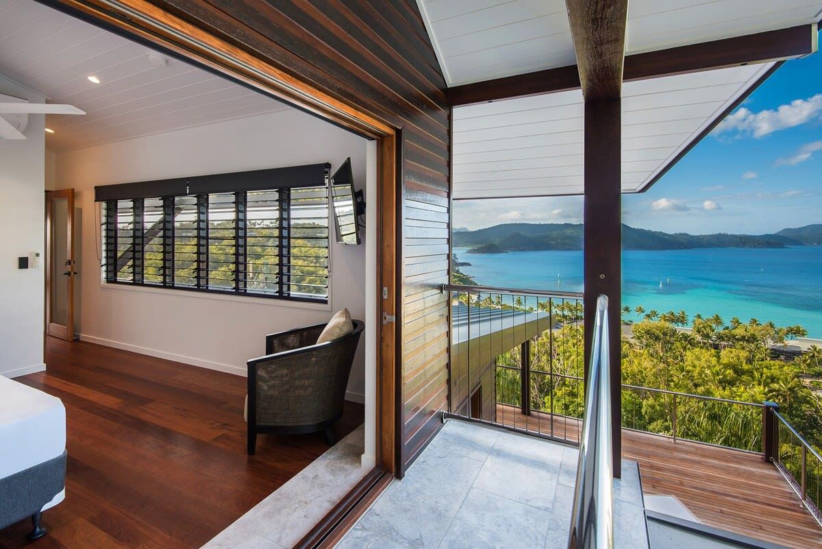 A modern interior with a large window overlooking a scenic ocean view.