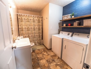 A laundry room with a washing machine, dryer, and a sink.