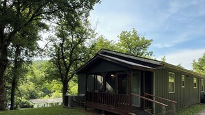 A small, single-story cabin with a porch and a staircase leading to the entrance. - Low Key Living Hideaway (Lavalette)