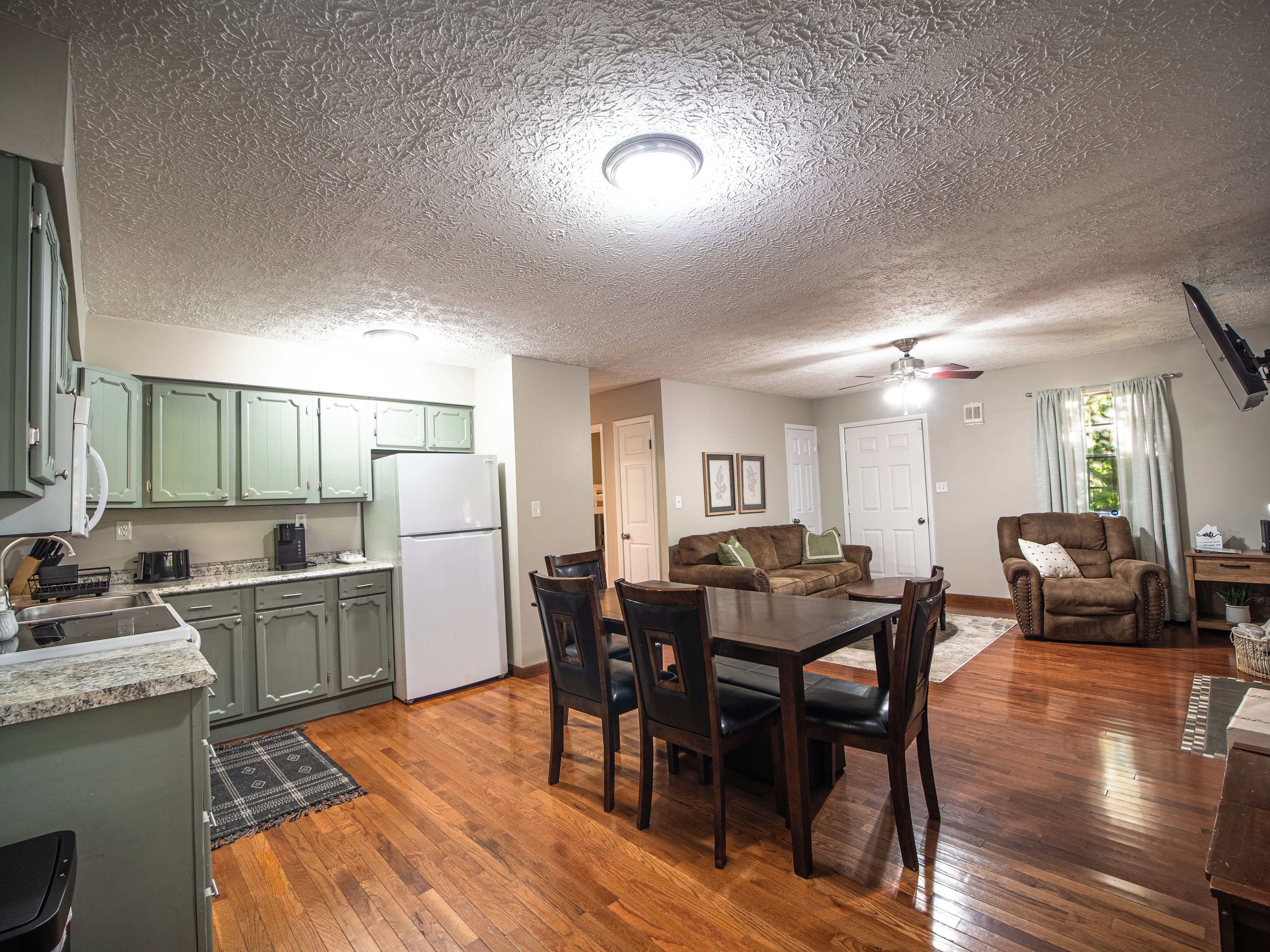 A compact living space with a kitchen, dining area, and a seating area.