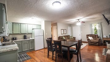 A compact living space with a kitchen, dining area, and a seating area.