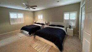 A bedroom with two beds, a ceiling fan, and windows with blinds. - NO DISPONIBLE LA CASA. (St. Cloud)