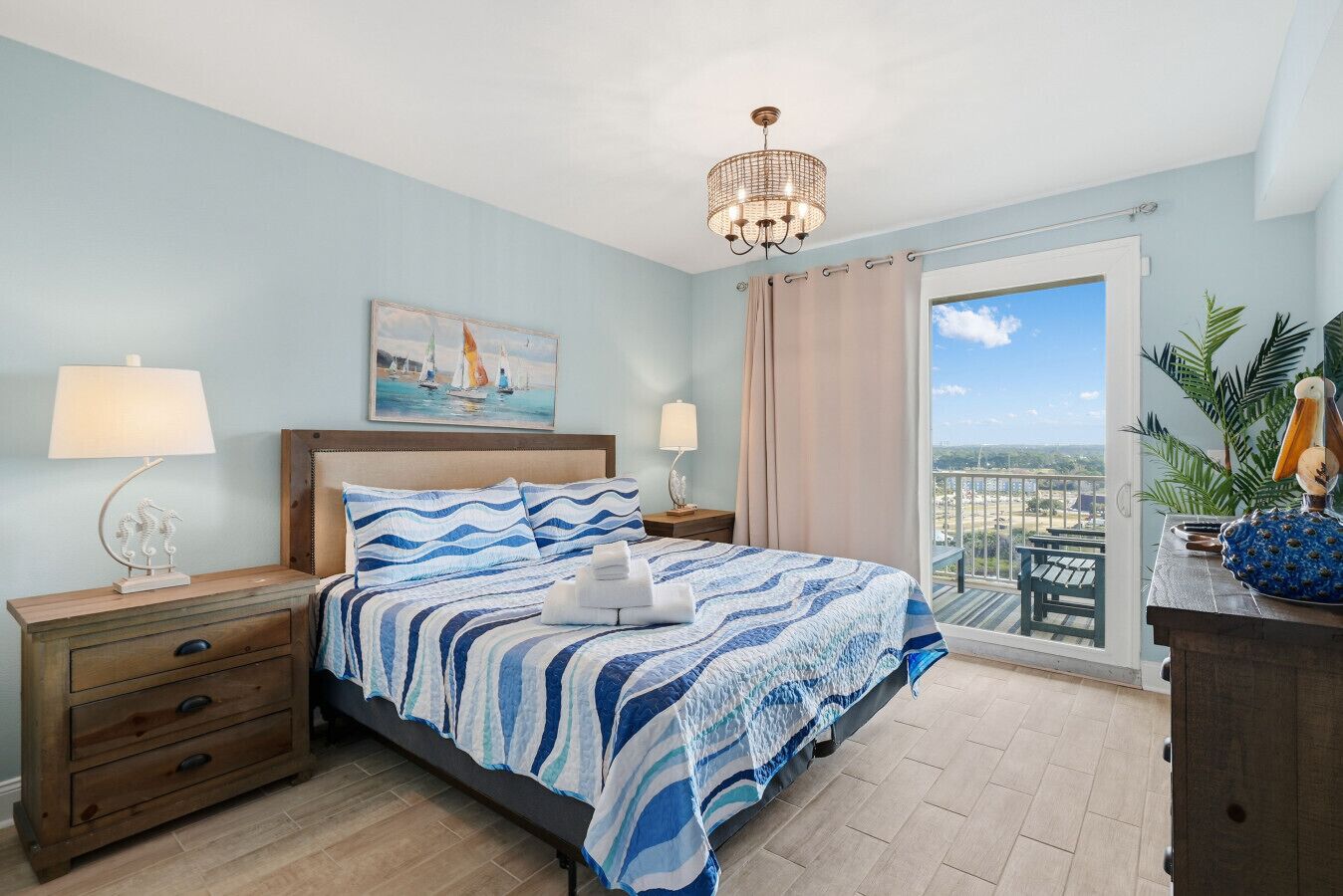 Bedroom with king sized bed, smart tv, and balcony access