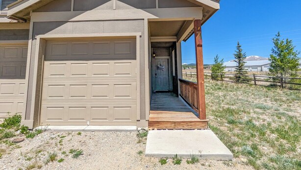 A single-story house with a covered porch, a garage, and a driveway.