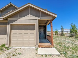 A single-story house with a covered porch, a garage, and a driveway.