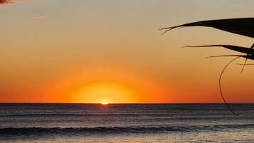 A sunset over the ocean with waves.