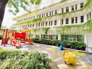 Children's play area - outdoor - Altiz Apartments at Bintaro by OkeStay (South Tangerang)