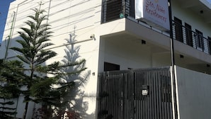 A modern building with a sign indicating it is a residence. - Sto. Nino Residences (Lucena)