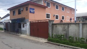 A multi-story building with a sign indicating 'Laurel Blue Suites'. - Laurel Blue Suites (Port Harcourt)