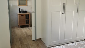 Un dormitorio con armario, espejo y lavabo.
