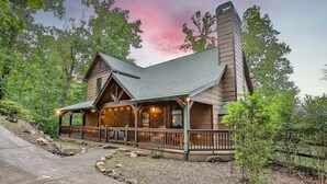 A log cabin with a porch, stone steps, and a chimney. - North Georgia Hideaway | Ellijay, GA (Ellijay)