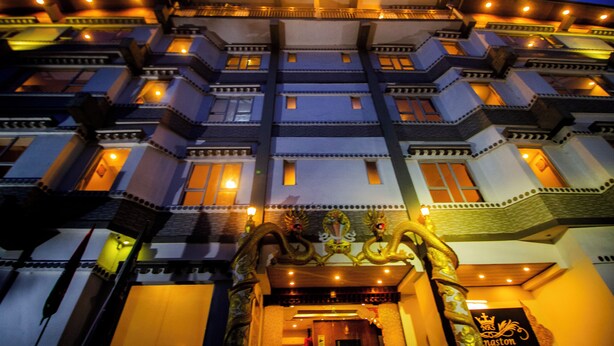 A multi-story building with a traditional architectural style, featuring balconies and a decorative entrance. - NRS KINGSTON (Gangtok)
