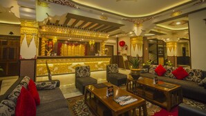 A traditional interior with sofas, a reception desk, and decorative elements. - NRS KINGSTON (Gangtok)