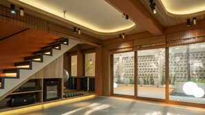 A modern interior with a staircase, built-in speakers, and a large window offering a view of a cityscape. - Stay Plus Hotel Bangkok (Bangkok)