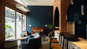A modern lounge area with a piano, seating arrangements, and a bar counter. - Stay Plus Hotel Bangkok (Bangkok)