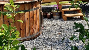 A wooden cabin with a blue door, a window, and a metal chimney. - Exquisite Shepherd's HUT With HOT TUB - Between Moor and sea (Camelford)