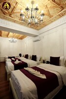 Deluxe Quadruple Room, Multiple Beds | Hypo-allergenic bedding, in-room safe, individually decorated, desk