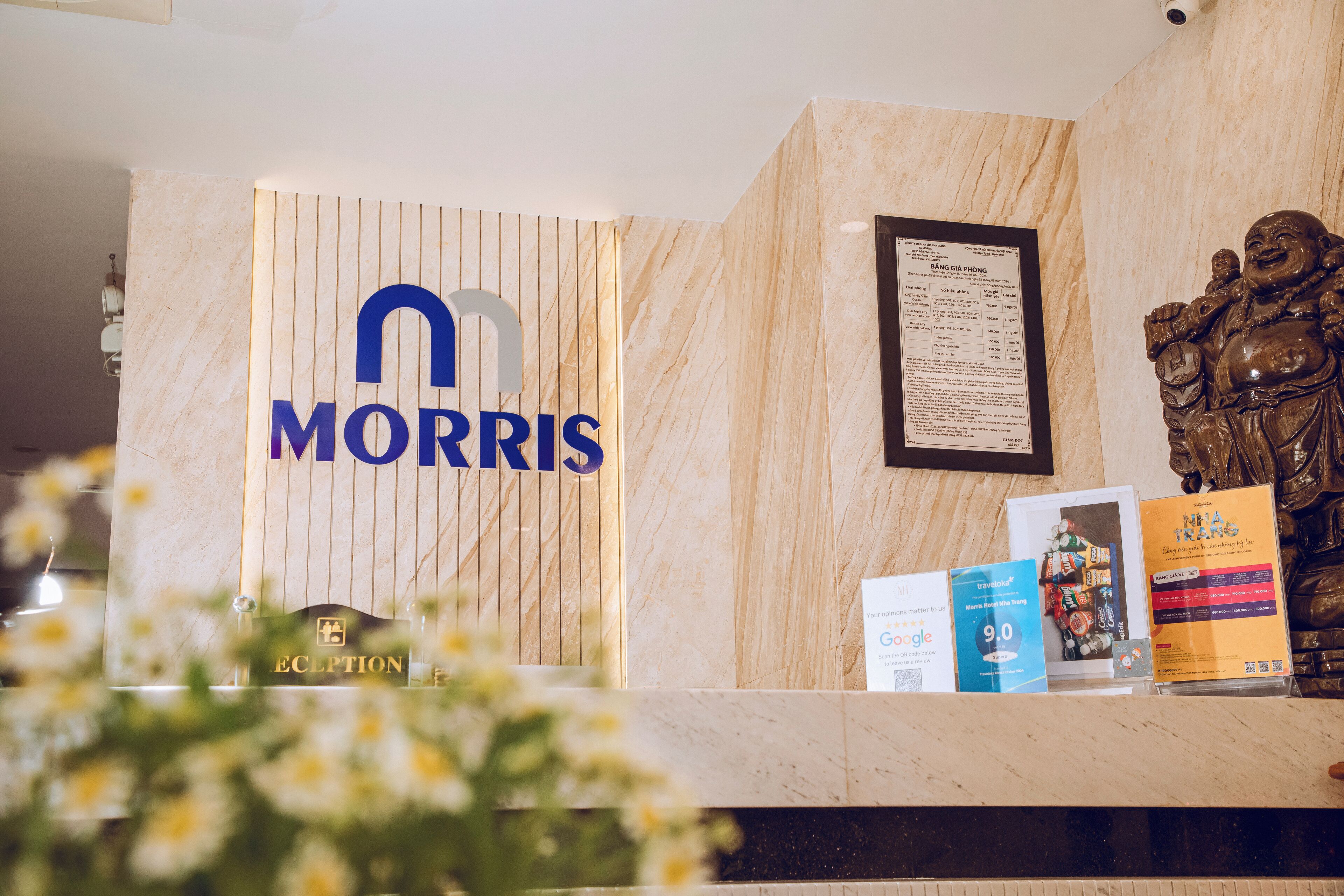 A reception desk with a wooden panel displaying the name "MORRIS" in blue letters.