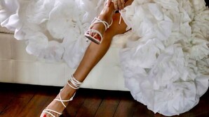 A person sitting on a bed with a white, ruffled wedding dress and white sandals. - Villa "Luxury Oleandra" with Private Pool, Big Garden and Barbecue (Dizzasco)