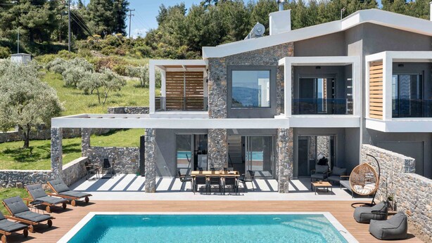 A modern two-story house with a swimming pool, outdoor seating, and stone walls. - K-Koni Villa, Agia Paraskevi by Halkidiki Villas (Pallini)