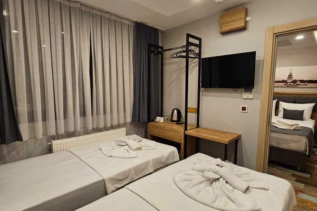 Family Quadruple Room | Free minibar items, in-room safe, desk, laptop workspace