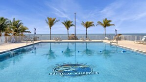 A swimming pool with a logo, palm trees, and a view of the ocean. - One bedroom  in United States of America, Marathon (Marathon)
