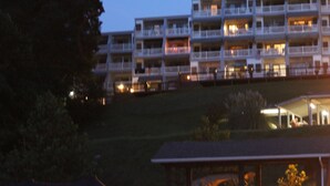 A multi-story hotel with balconies and a covered outdoor area. - Cozy WATERFRONT condo in a quiet cove.   Private Boat launch (Moneta)