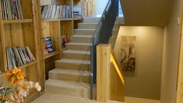 A staircase with bookshelves on either side, leading to a lower level.