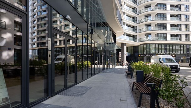 A modern building with large glass windows and a curved facade.