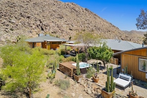 A desert-style house with a patio, a hot tub, and cacti. - Moonbeam Mountain - Stylish Suites + Hot Tub (Joshua Tree)