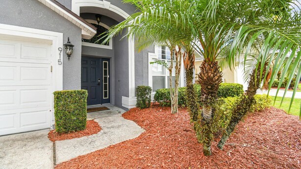 A residential house with a garage, a front door, and a driveway.