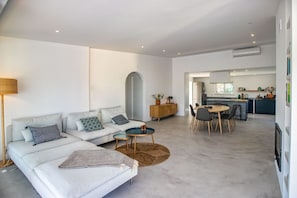 Relax in this inviting living area with a sofa, coffee table, and dining space.