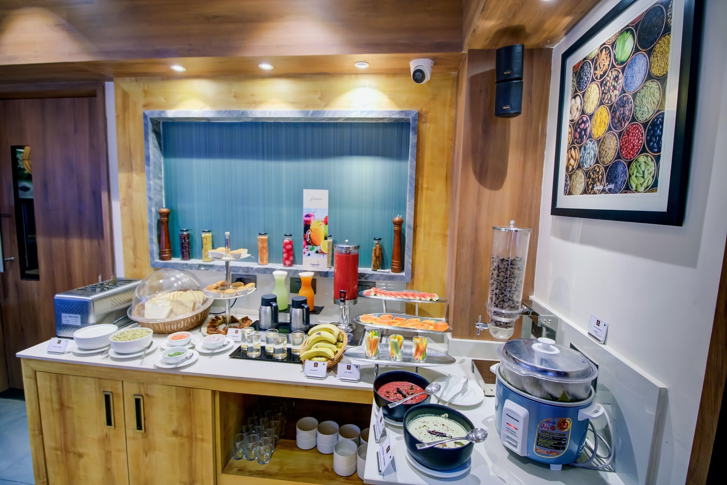 A buffet setup with various food items and a rice cooker.