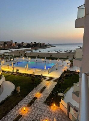 A resort pool area with a view of the beach and ocean. - A435 Comfy & Cozy in Scandic Resort with beach and pools (Hurghada)