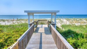 A wooden boardwalk leading to a white gazebo with a view of the beach and ocean. - Enjoy a spacious oceanfront duplex at Codfather Unit 2 (Oak Island)