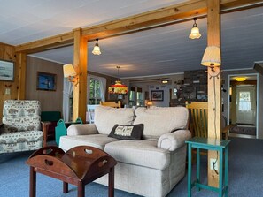A cozy living room with a sofa, armchairs, and a wooden coffee table. - Lake and Mountain views! (Sanbornton)