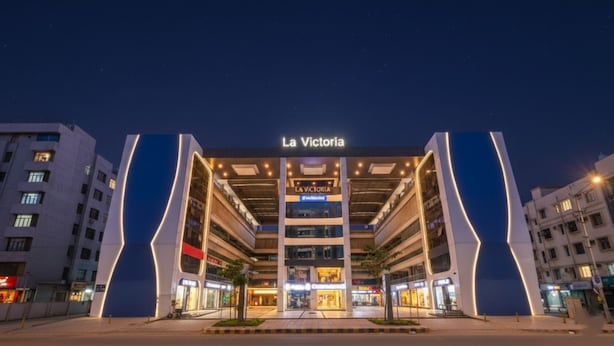 A multi-story building with a prominent entrance labeled "La Victoria." - Fabhotel La Victoria (Surat)