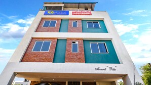 A multi-story hotel with a modern design, featuring a rooftop terrace and a prominent sign for 'Hotel Unity Landmark'. - Fabhotel Unity Landmark (Indore)